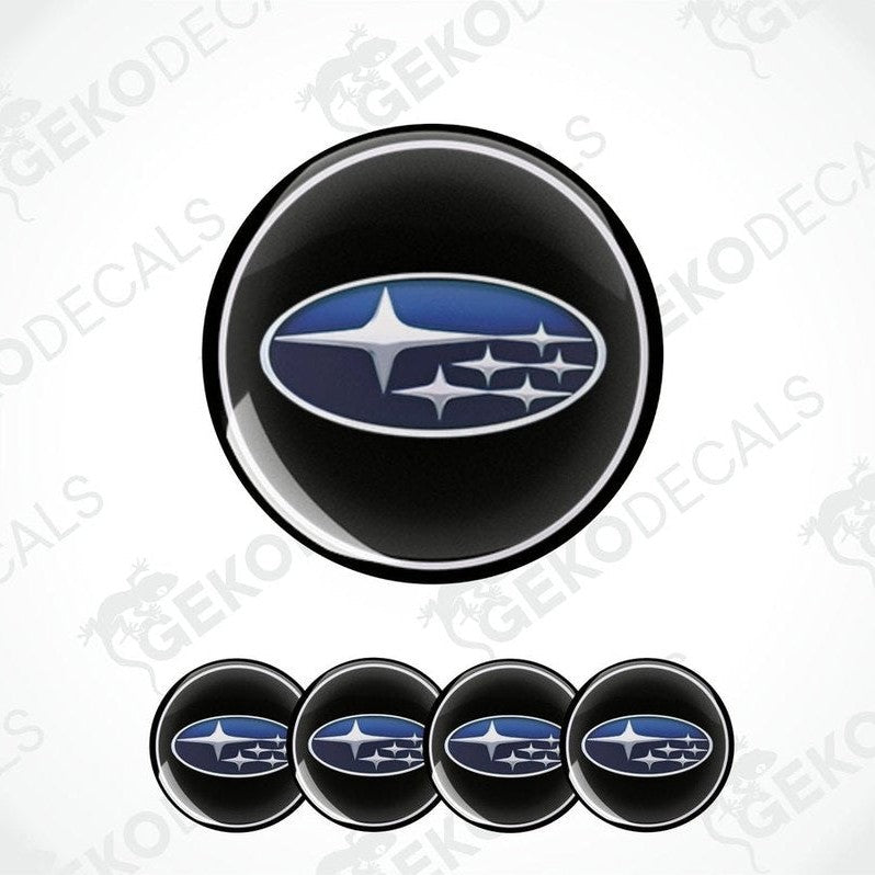 A set of four black vinyl stickers with a blue and white Subaru logo.