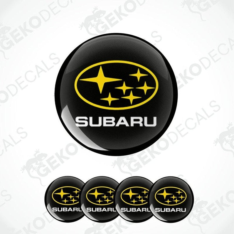 A set of four black vinyl stickers with the SUBARU brand logo and stars in yellow.