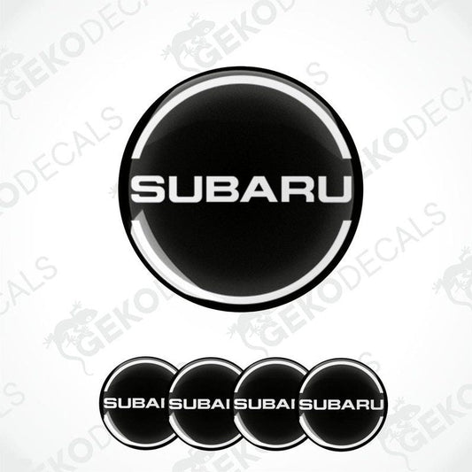 A set of four black vinyl stickers with the word 'SUBARU' and a logo depicting a wheel, placed against a white background with the Gecko Decals logo.