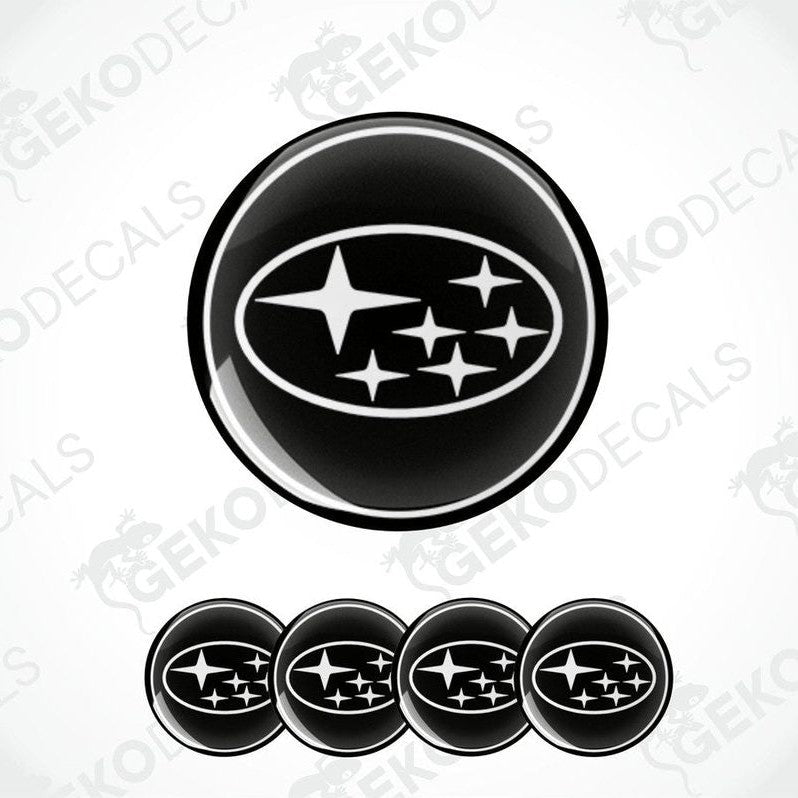 A set of four black vinyl stickers with a star and the logo of the Subaru car brand.