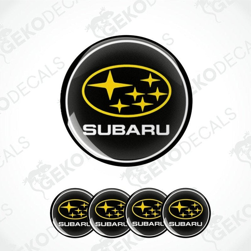 A set of four black, yellow, and white vinyl stickers with a geometric design, featuring the word 'SUBARU' in bold letters.
