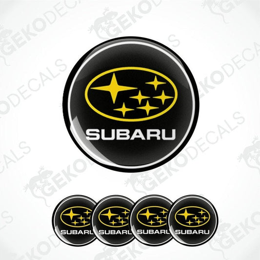 A set of four black, yellow, and white vinyl stickers with a geometric design, featuring the word 'SUBARU' in bold letters.