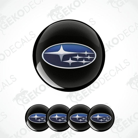 A set of four black vinyl stickers with a blue and white Subaru logo