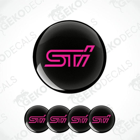 A set of four black vinyl stickers with the word ' SUBARU STI' in pink, intended for use on vehicle wheels.