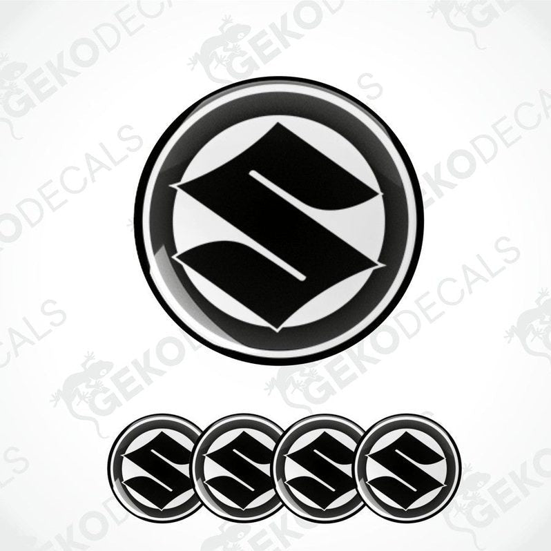 A set of four black and white vinyl stickers with the SUZUKI brand logo.