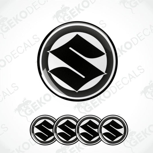 A set of four black and white vinyl stickers with the SUZUKI brand logo.