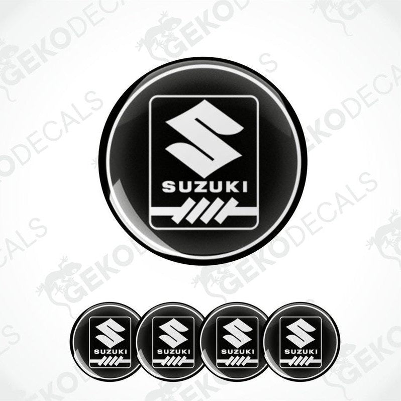A set of four black vinyl stickers with the SUZUKI brand logo.