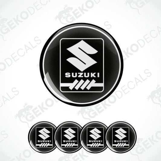 A set of four black vinyl stickers with the SUZUKI brand logo.