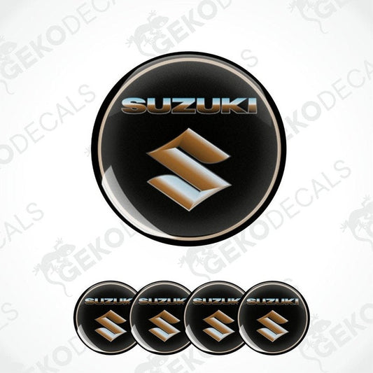 A set of black, silver, and gold colored vinyl decals with the SUZUKI logo, designed for use on vehicles.