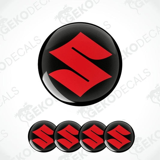 A set of four round vehicle decals featuring the SUZUKI logo in red on a black background.