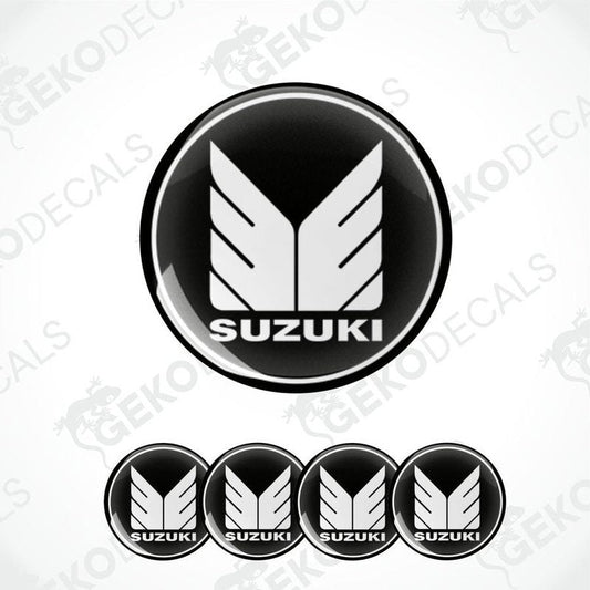 A set of four black vinyl stickers with the SUZUKI brand logo.