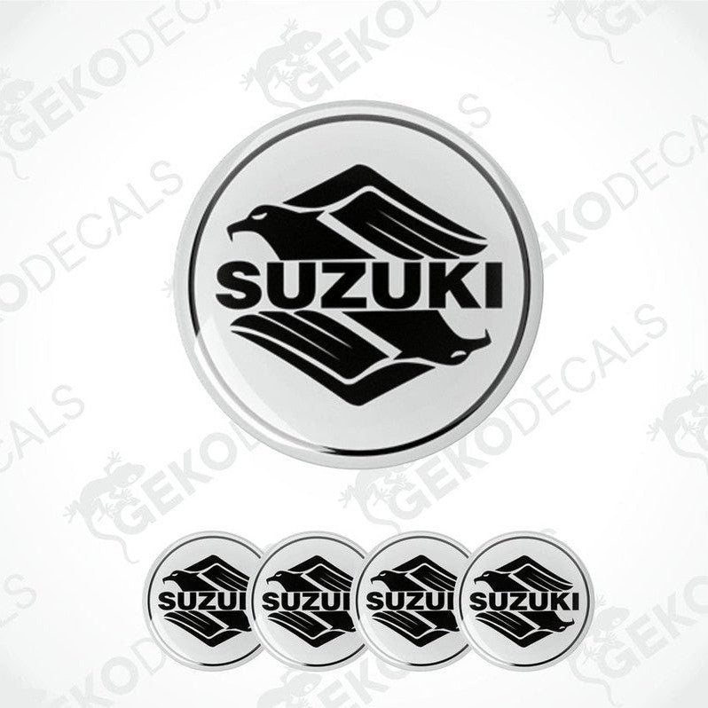 A set of four circular vinyl stickers with a Suzuki logo design, intended for use on vehicles.