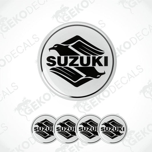 A set of four circular vinyl stickers with a Suzuki logo design, intended for use on vehicles.