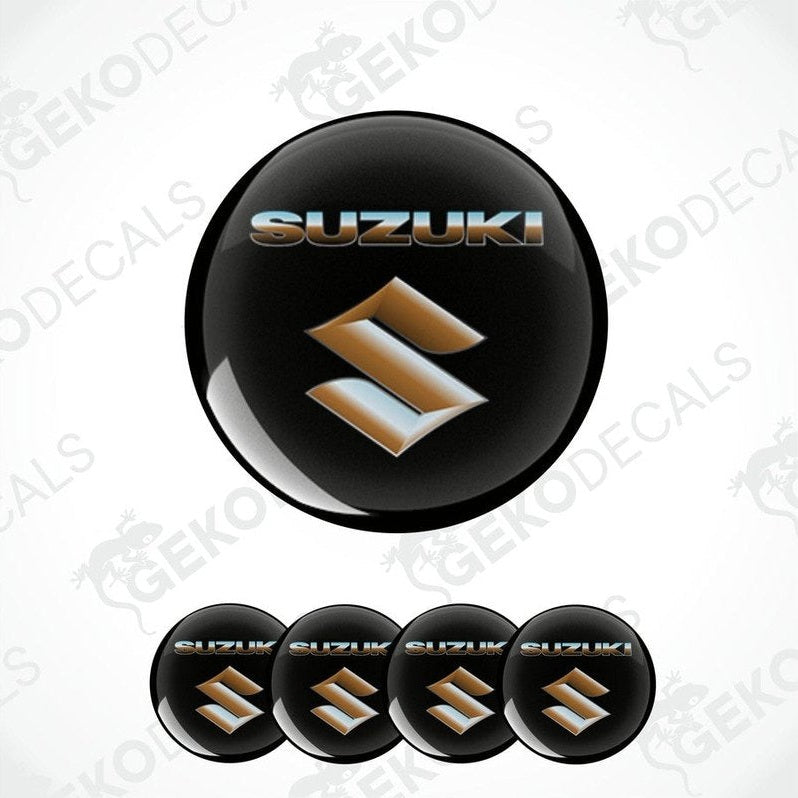 A set of black, gold, and silver SUZUKI branded vinyl decals with a polyurethane coating, designed for use on vehicles.