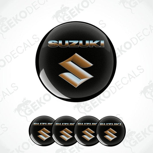 A set of black, gold, and silver SUZUKI branded vinyl decals with a polyurethane coating, designed for use on vehicles.