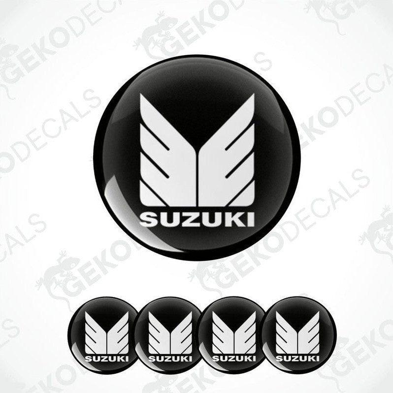 A set of four black vinyl stickers with the SUZUKI brand logo design.