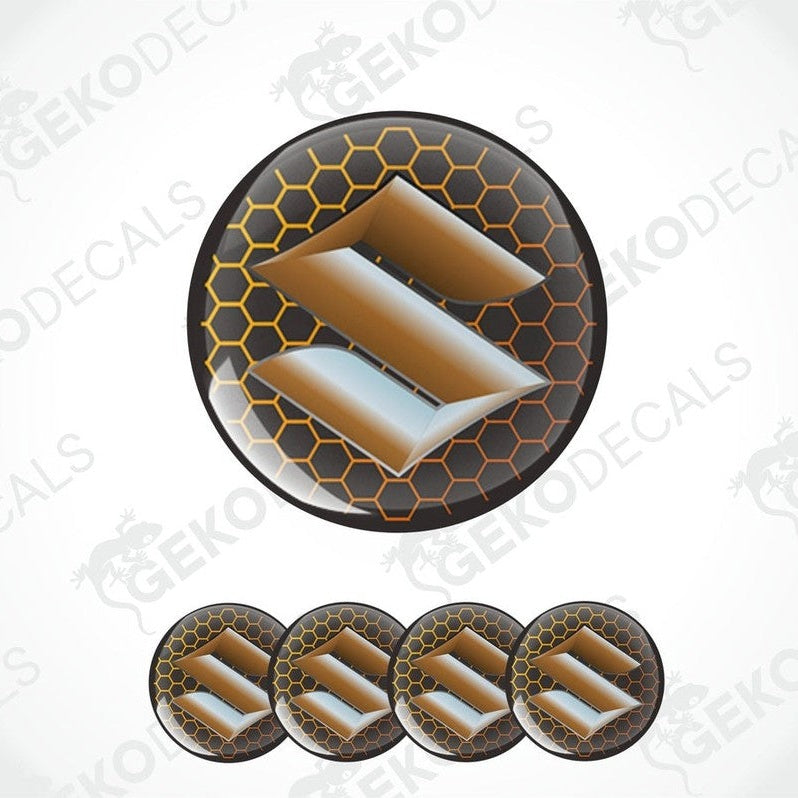 A set of four round vinyl decals with the letter 'SUZUKI' in the center, predominantly in orange and black colors, with a honeycomb pattern around the 'SUZUKI'.