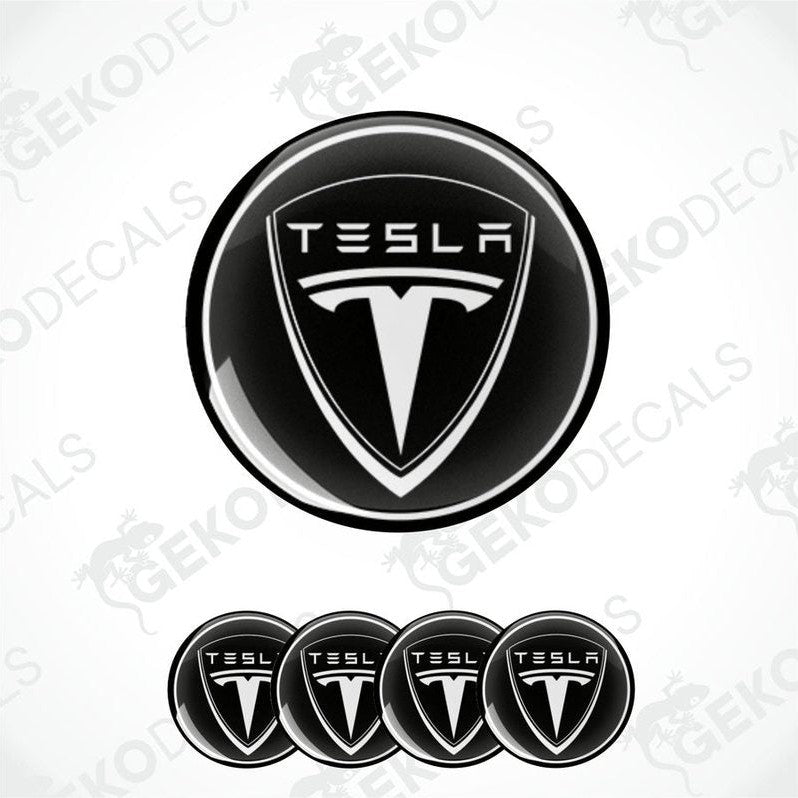 Set of four black and white vinyl decals with the Tesla logo, designed for use as car wheel and wheel cap stickers.
