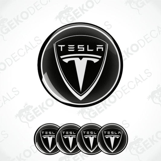 Set of four black and white vinyl decals with the Tesla logo, designed for use as car wheel and wheel cap stickers.