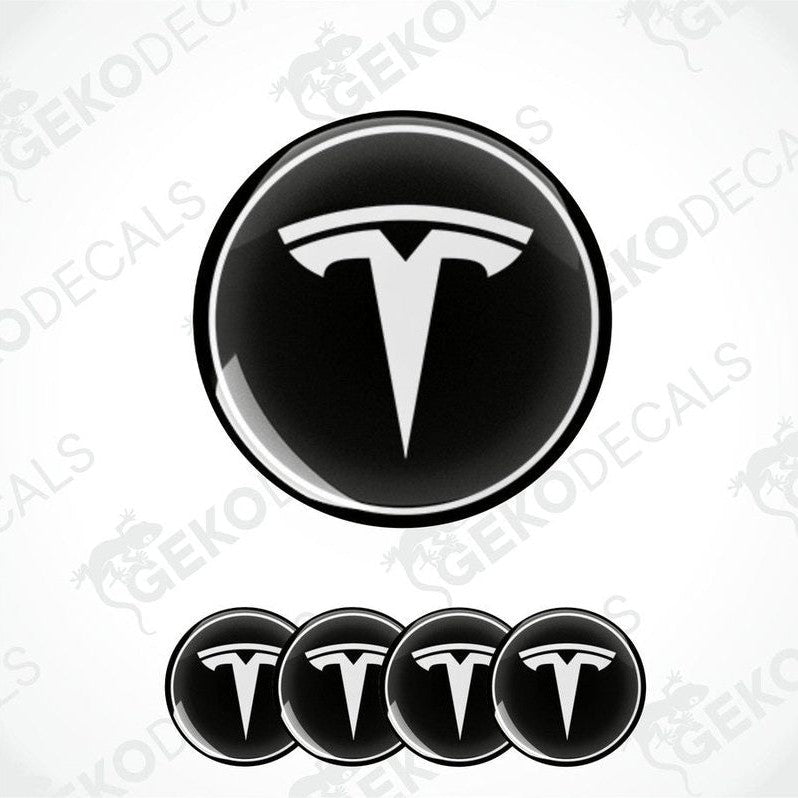 A set of four black vinyl stickers with a Tesla logo on each.
