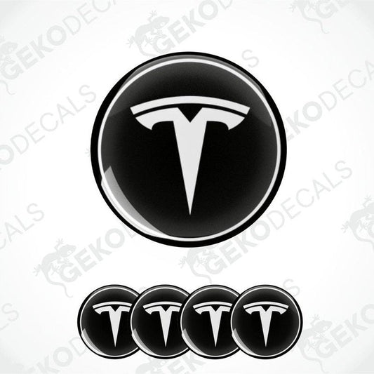 A set of four black vinyl stickers with a Tesla logo on each.