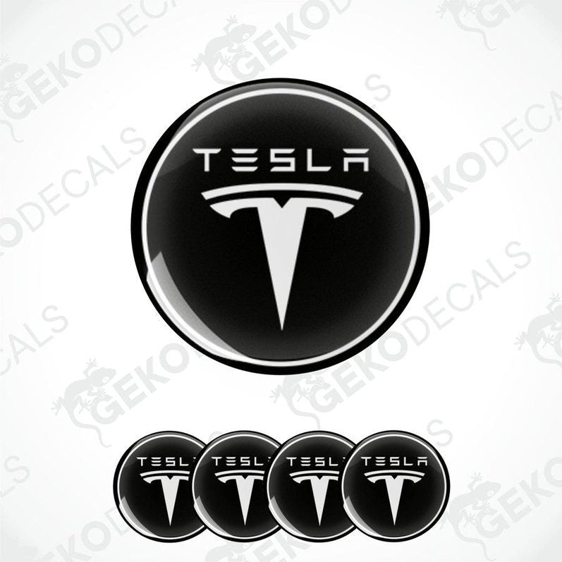 A set of four black vinyl stickers with a Tesla logo on each.