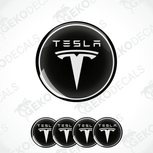 A set of four black vinyl stickers with a Tesla logo on each.