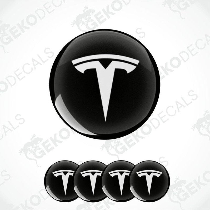 Set of four black and white vinyl decals with the TESLA logo, displayed on a white background.