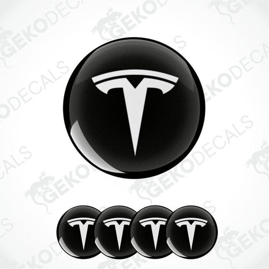 Set of four black and white vinyl decals with the TESLA logo, displayed on a white background.