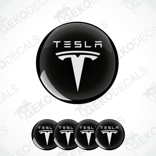 Set of four black and white vinyl decals with the Tesla logo, intended for use on a vehicle's wheels and other surfaces.