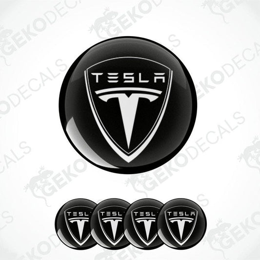 A set of four black vinyl stickers with a Tesla logo design.