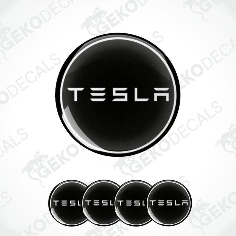 Set of four black and white vinyl decals with the TESLA logo, displayed on a white background.