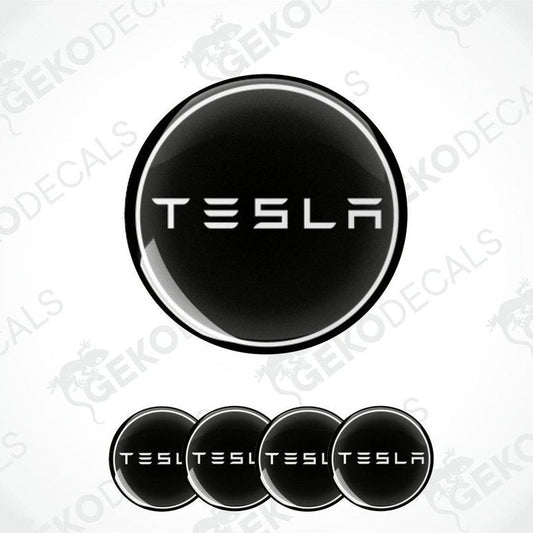 Set of four black and white vinyl decals with the TESLA logo, displayed on a white background.