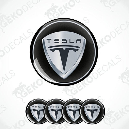 A set of four round black vinyl stickers with the Tesla brand logo in the center.