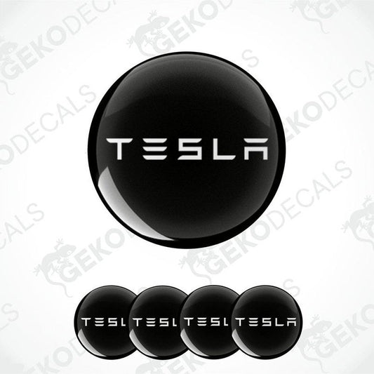 Set of four black and white vinyl decals with the TESLA logo, displayed on a white background.