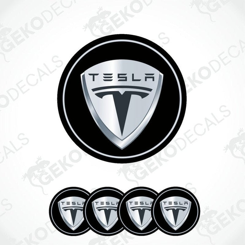 A set of four round black vinyl stickers with the Tesla brand logo in the center.