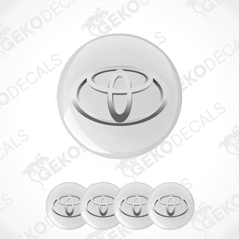 A set of four white vinyl decals with the TOYOTA logo, designed for use as car wheel caps.