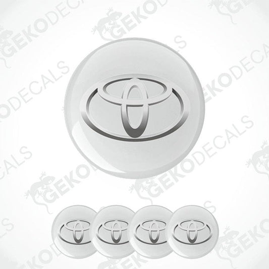 A set of four white vinyl decals with the TOYOTA logo, designed for use as car wheel caps.