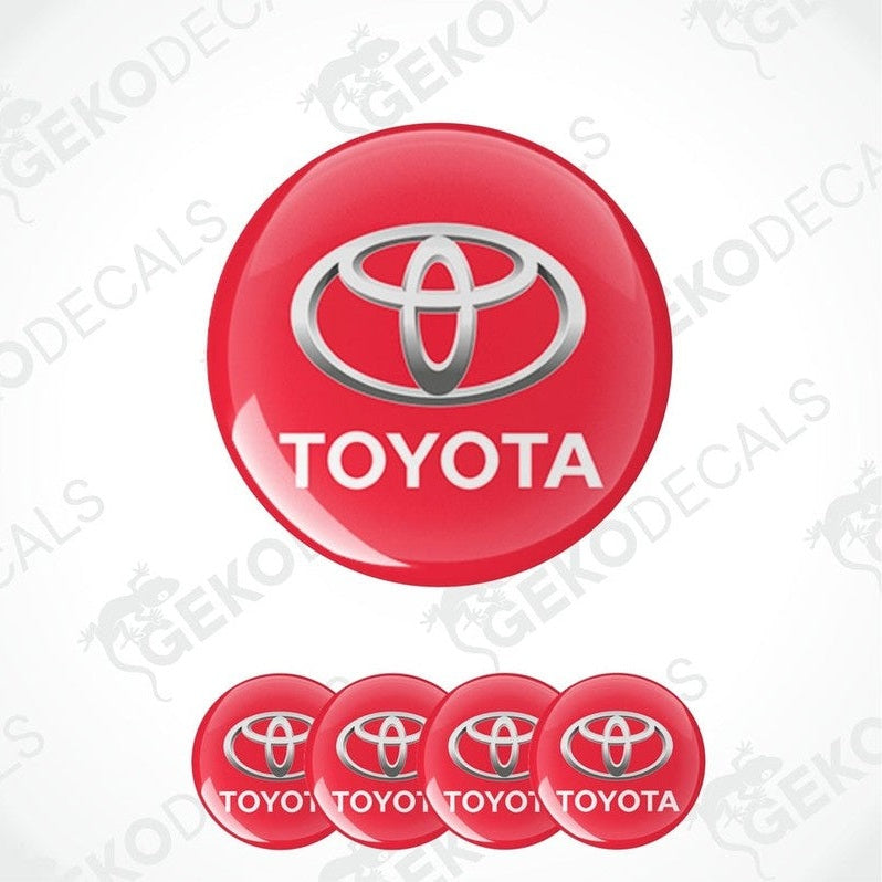 A set of four red vinyl stickers with the Toyota brand logo on them.