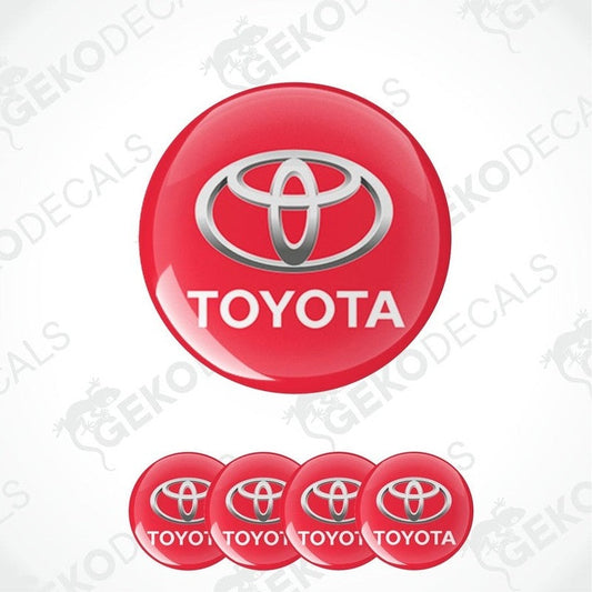 A set of four red vinyl stickers with the Toyota brand logo on them.