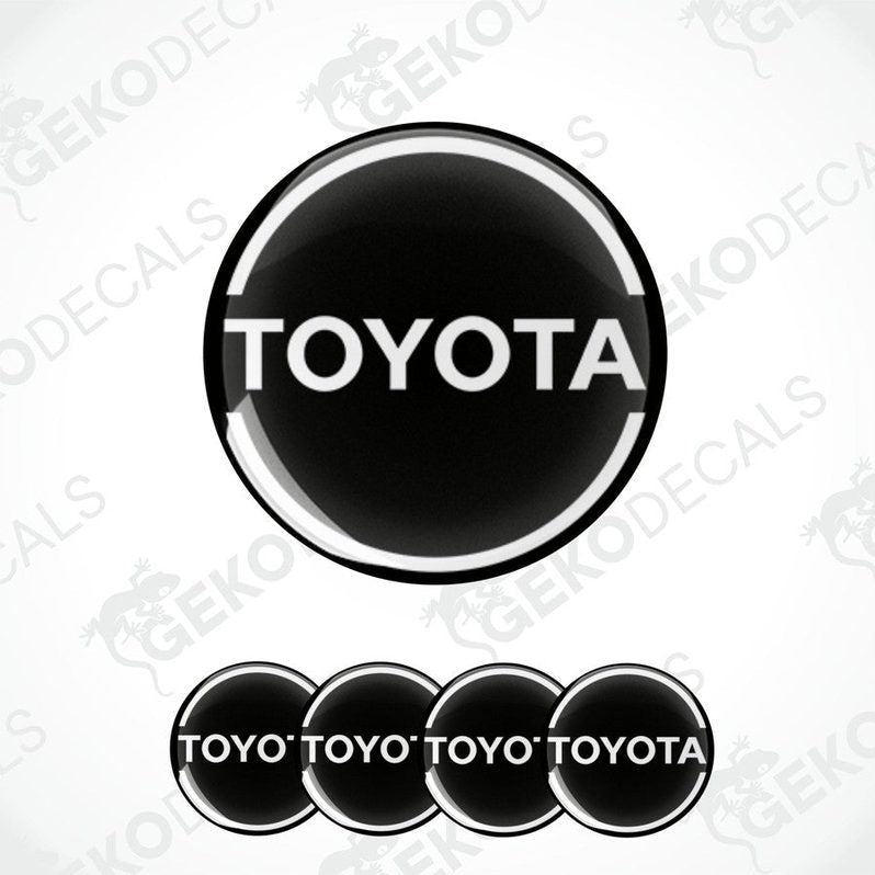 A set of black vinyl decals with the TOYOTA logo, including one large decal and four smaller ones with the text 'TOYOTA' arranged in a pattern.