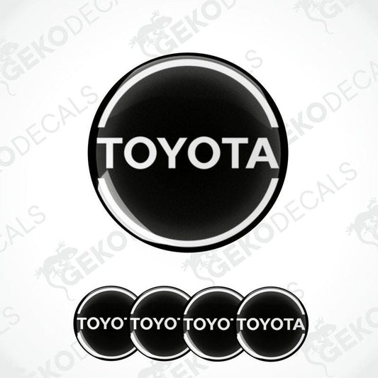 A set of black vinyl decals with the TOYOTA logo, including one large decal and four smaller ones with the text 'TOYOTA' arranged in a pattern.