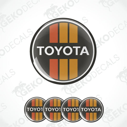 A set of four black, red, and white vinyl stickers with the letters 'TOYOTA' in the center.