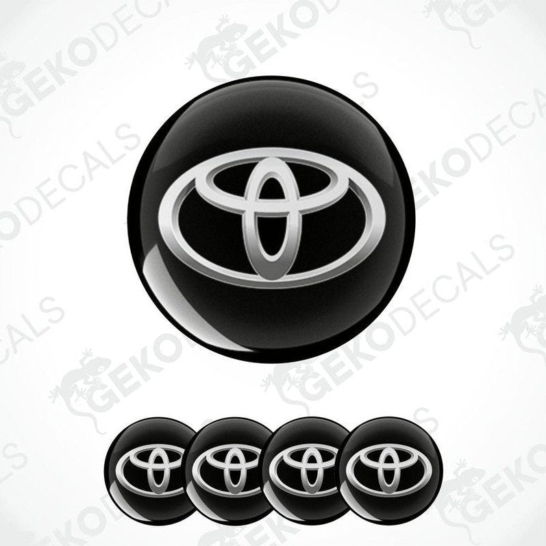 A set of four black vinyl stickers with a Toyota logo, designed for use as car decals.