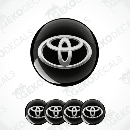 A set of four black vinyl stickers with a Toyota logo, designed for use as car decals.
