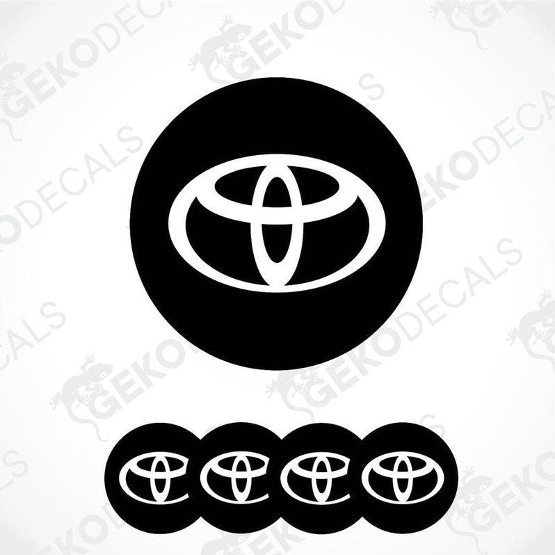 A set of four round car decals with the Toyota logo in black and white.