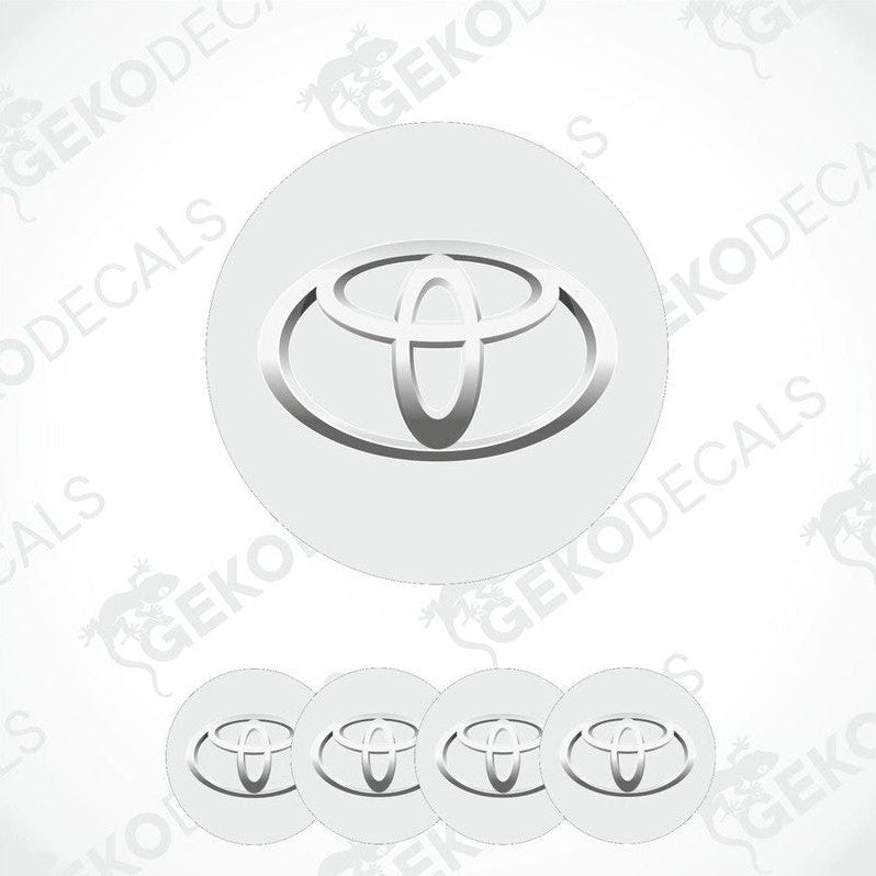 A set of four white vinyl decals with the TOYOTA logo, designed for use as car wheel caps.