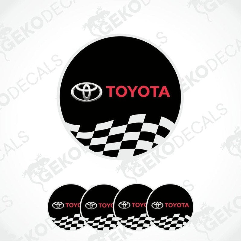 A set of four black vinyl stickers with the Toyota logo and a checkered pattern.