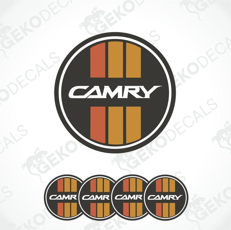 A set of four black, red, and orange vinyl stickers with the word 'CAMRY' in the center, designed for use on car wheel caps.