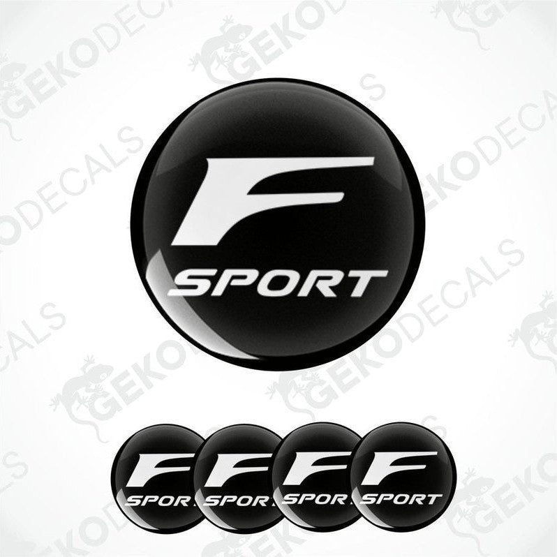 A set of four black vinyl stickers with the TOYOTA F SPORT logo printed on them.
